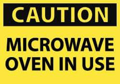 NMC - Accident Prevention Label, Header: CAUTION - Legend: Caution - Microwave Oven in Use, English, Black & Yellow, 5" Long x 3" High, Sign Muscle Finish - All Tool & Supply